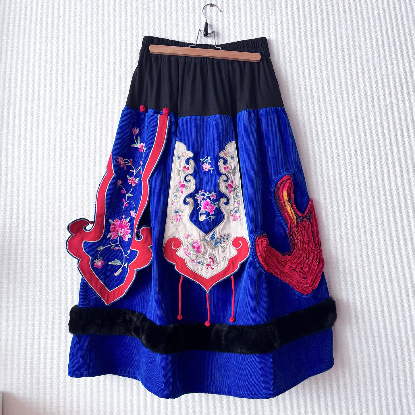 Full view of a iris blue Chinese-inspired skirt.