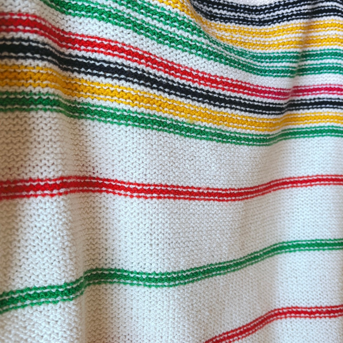 Another detailed view of the Chic Green Spring Sweater’s unique knit design in soft colorful tones