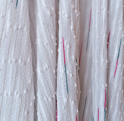 Close-up of secondhand white robe showing detailed texture and fabric quality