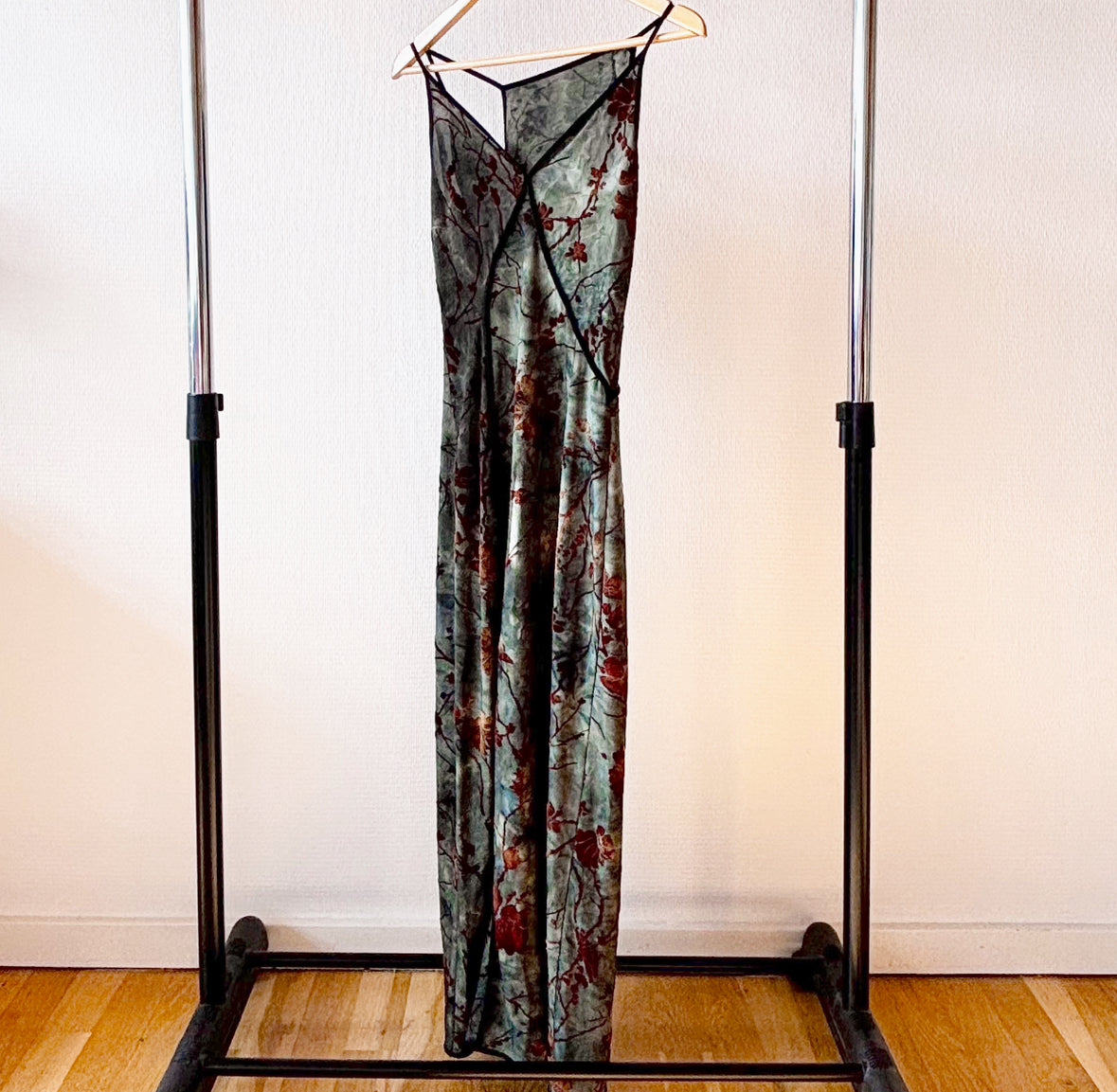 Elegant green summer dress displayed on a hanger