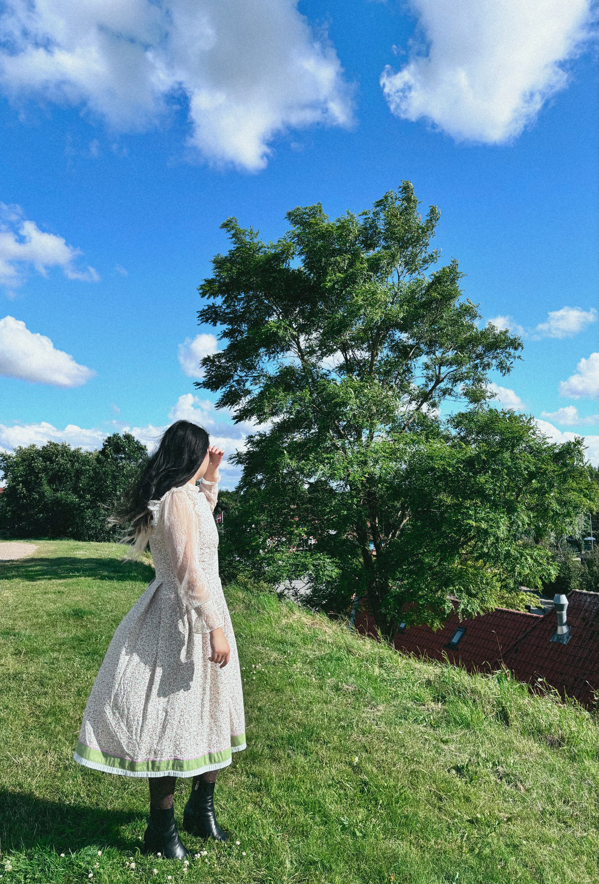 model wearing floral folkcore dress, in outdoor setting