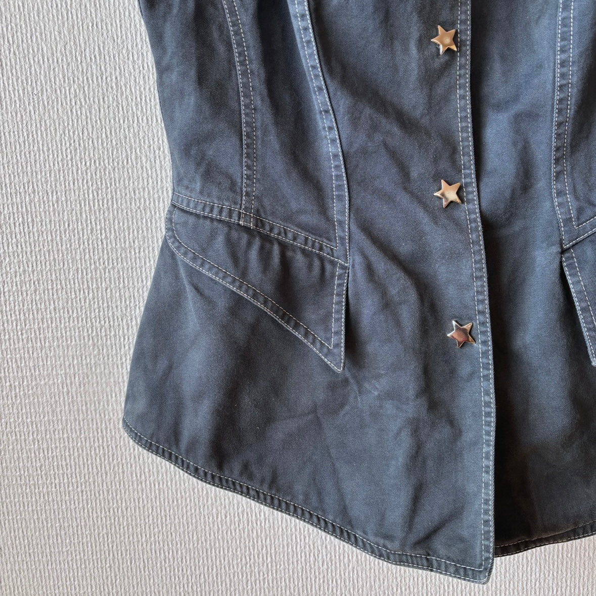 Close-up of the bottom front edge of the Thierry Mugler ACTIV Label Dark Blue Vest, showing hemline and fabric.